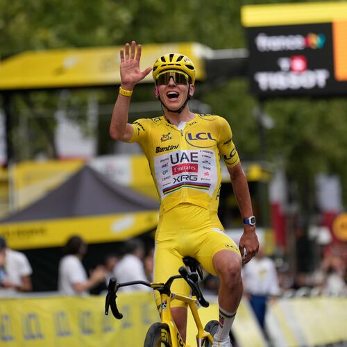 Slovenia's Tadej Pogacar, wearing the overall leader's yellow jersey, celebrates as he crosses the finish line of the last stage of the Tour de France cycling race with start and finish in Paris, Sunday, July 26, 2026. (AP Photo/Mosa'ab Elshamy)