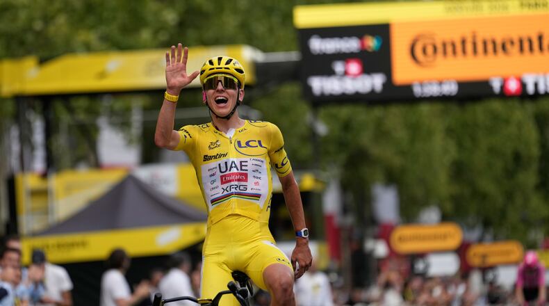 Slovenia's Tadej Pogacar, wearing the overall leader's yellow jersey, celebrates as he crosses the finish line of the last stage of the Tour de France cycling race with start and finish in Paris, Sunday, July 26, 2026. (AP Photo/Mosa'ab Elshamy)