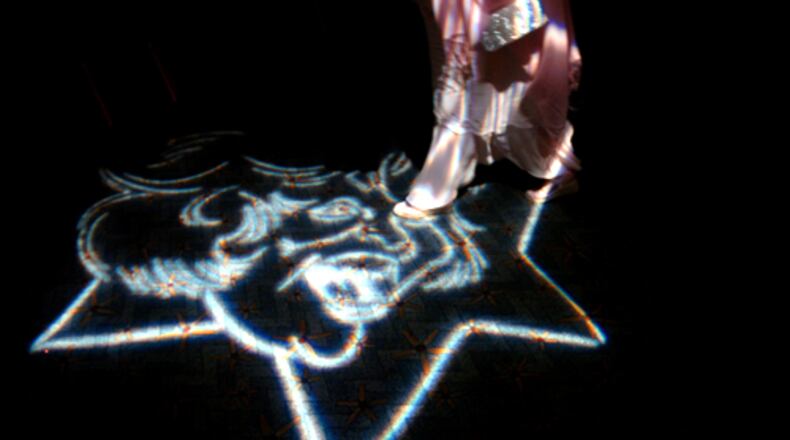 The face of the late actress Suzi Bass, for whom Atlanta's theater awards are named, is projected on the floor at a past awards ceremony. AJC File
