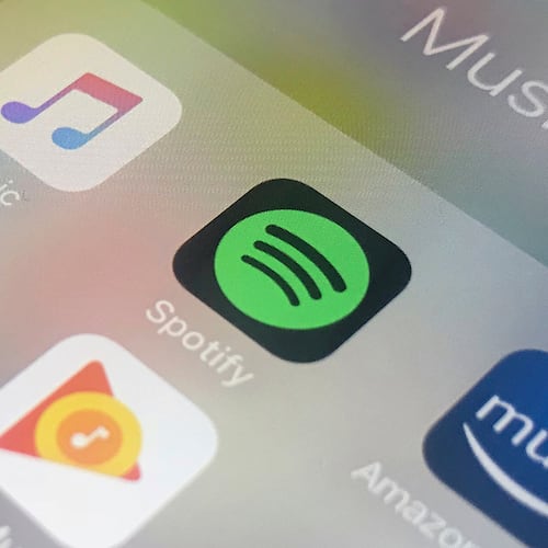 FILE - Music streaming apps, clockwise from top left, Apple, Spotify, Amazon and Google are displayed on an iPhone in New York, Jan. 28, 2018. (AP Photo/Jenny Kane, File)
