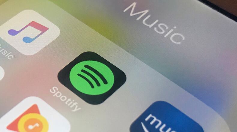 FILE - Music streaming apps, clockwise from top left, Apple, Spotify, Amazon and Google are displayed on an iPhone in New York, Jan. 28, 2018. (AP Photo/Jenny Kane, File)