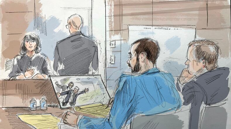 In this courtroom sketch, a witness describes video of an alleged attack on Salman Rushdie by Hadi Matar, in federal court in Buffalo, N.Y., Wednesday, July 22, 2026. Matar, foreground, is seated with his lawyer's co-council. (Alexandra Newbould via AP)