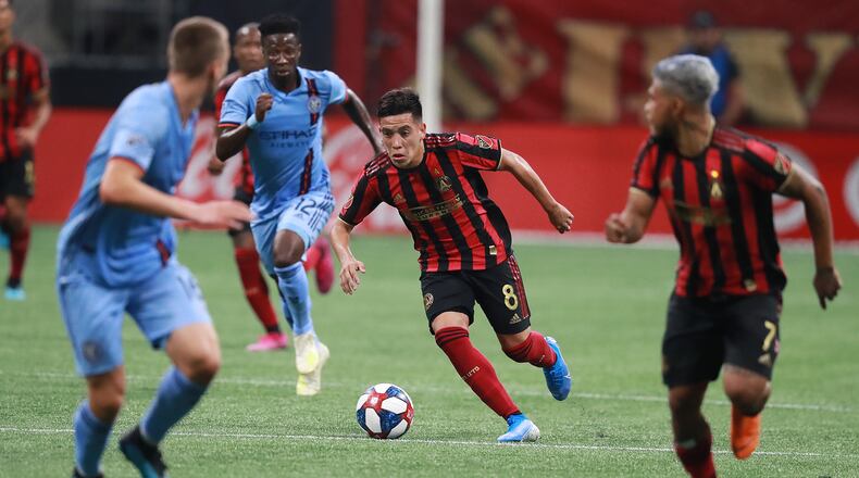 August 11, 2019 Atlanta: Atlanta United midfielder Ezequiel Barco works his way through New York City FC defenders in their soccer match on Sunday, August 11, 2019, in Atlanta.   Curtis Compton/ccompton@ajc.com