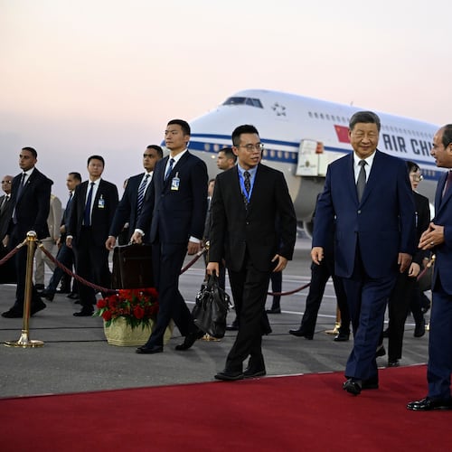 Chinese President Xi Jinping, third from right, is welcomed by Egyptian President Abdel-Fattah el-Sissi, second from right, followed by their wives Peng Liyuan, covered, and Entissar Amer, right, at Cairo International Airport in Cairo, Egypt, Tuesday, Sept. 1, 2026. (Khaled Desouki/Pool Photo via AP)