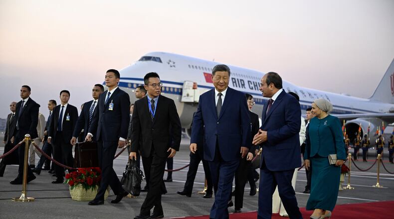 Chinese President Xi Jinping, third from right, is welcomed by Egyptian President Abdel-Fattah el-Sissi, second from right, followed by their wives Peng Liyuan, covered, and Entissar Amer, right, at Cairo International Airport in Cairo, Egypt, Tuesday, Sept. 1, 2026. (Khaled Desouki/Pool Photo via AP)