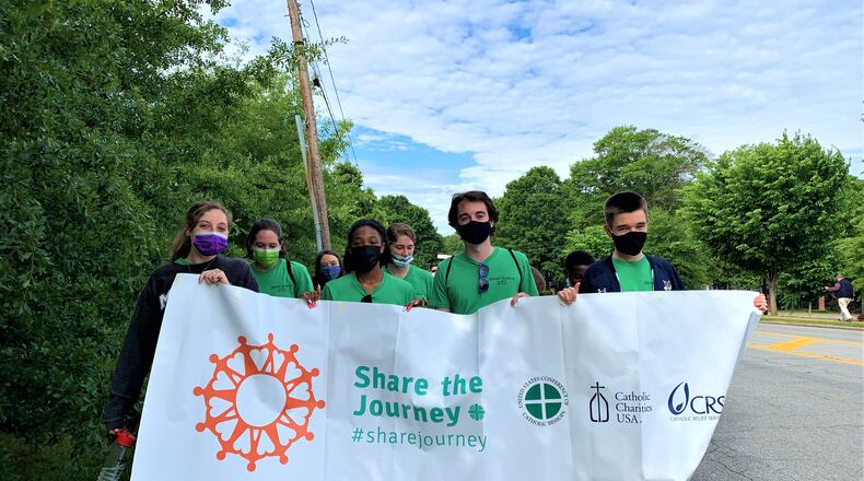 Students from Marist School lead the "Share the Journey" walk that raised funds for refugee organizations.