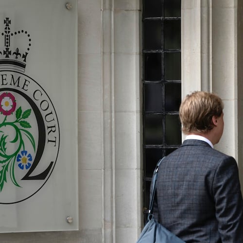 FILE - A man enters the Supreme Court in London, on Oct. 9, 2023. (AP Photo/Kin Cheung, File)