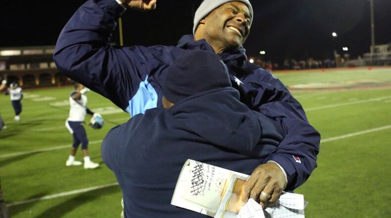 December 4, 2015 - Norcross, Ga: Pace Academy head coach Chris Slade, facing, celebrates with offensive coordinator Kevin Johnson after their win over GAC in the Class AA semi-final at Greater Atlanta Christian, Friday, December 5, 2015, in Norcross, Ga. Pace Academy defeated GAC 45-20. PHOTO / JASON GETZ December 4, 2015 - Norcross, Ga: Pace Academy head coach Chris Slade, facing, celebrates with offensive coordinator Kevin Johnson after their win over GAC in the Class AA semi-final at Greater Atlanta Christian, Friday, December 5, 2015, in Norcross, Ga. Pace Academy defeated GAC 45-20. PHOTO / JASON GETZ