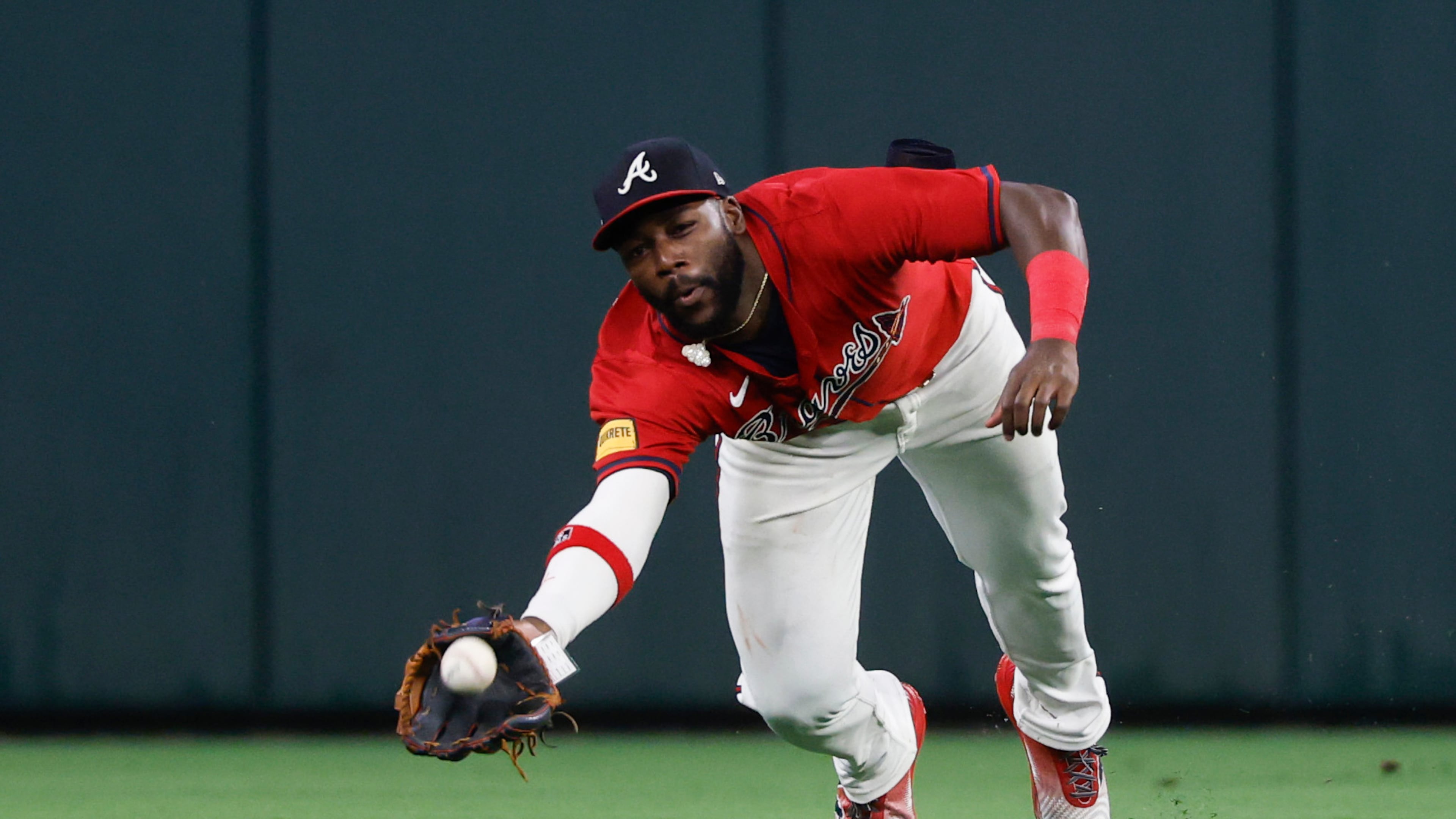 Atlanta Braves outfielder Michael Harris II makes a diving catch for the out on Philadelphia Phillies'Kyle Schwarber during the fourth inning of a baseball game, Friday, June 27, 2025, in Atlanta. (AP Photo/Butch Dill)