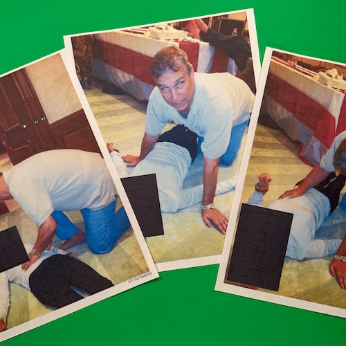 EDS NOTE: GRAPHIC CONTENT - Images from an undated and redacted document released by the U.S. Department of Justice, photographed Saturday, Jan. 31, 2026, show Andrew Mountbatten-Windsor, formerly known as Prince Andrew, leaning over an unidentified person. (AP Photo/Jon Elswick)