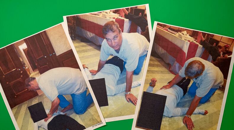 EDS NOTE: GRAPHIC CONTENT - Images from an undated and redacted document released by the U.S. Department of Justice, photographed Saturday, Jan. 31, 2026, show Andrew Mountbatten-Windsor, formerly known as Prince Andrew, leaning over an unidentified person. (AP Photo/Jon Elswick)