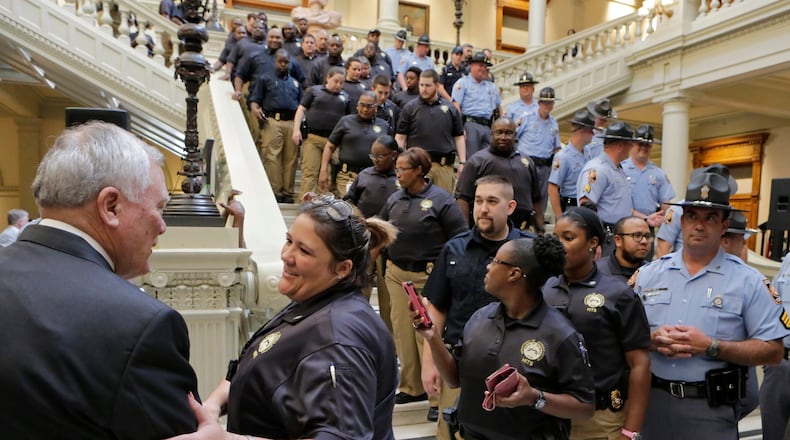 Cortney Gunter, a probation and parole officer with the Department of Juvenile Justice, shakes hands with Gov. Nathan Deal in this September 2016 file photo.