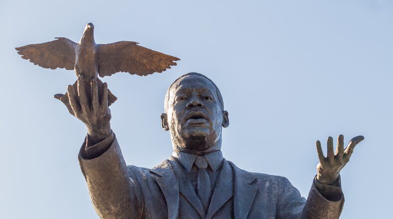 City of Atlanta unveils the bronze statue "Hope Moving Forward" honoring the life and legacy of Dr. Martin Luther King Jr. on Friday, January 15, 2021 near the intersection of Northside Drive and MLK Jr Drive. This is the first of seven art installations commissioned by the city to honor MLK. (Jenni Girtman for The Atlanta Journal Constitution)