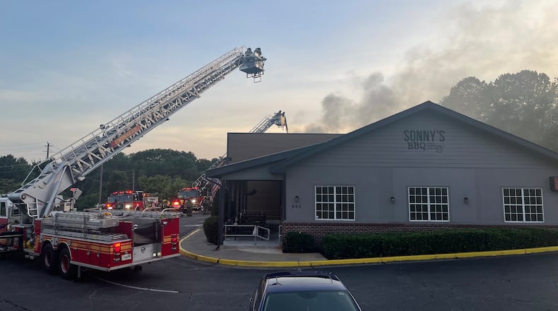 A fire at Sonny's BBQ in Lawrenceville briefly threatened power lines in the area.