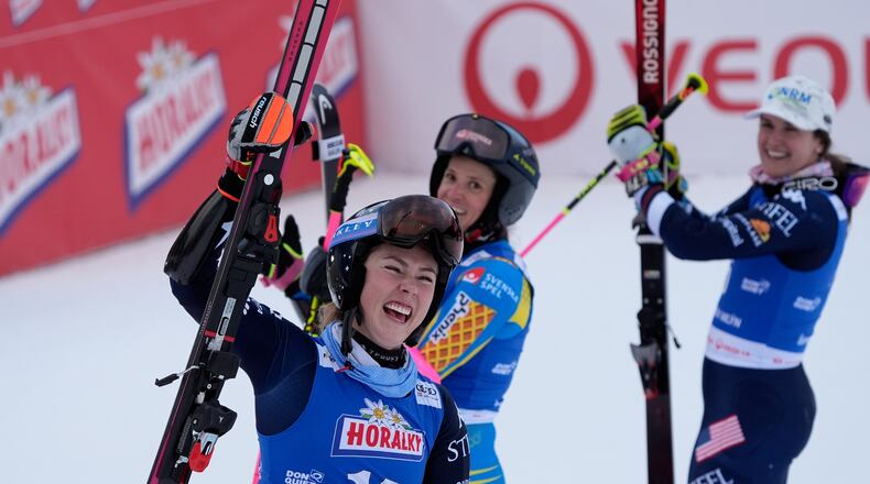 From left, United States' Mikaela Shiffrin, Sweden's Sara Hector and United States' Paula Moltzan at finish line during a women¥s alpine ski, World Cup giant slalom, in Spindleruv Mlyn, Czech Republic, Saturday, Jan. 24, 2026. (AP Photo/Giovanni Auletta)