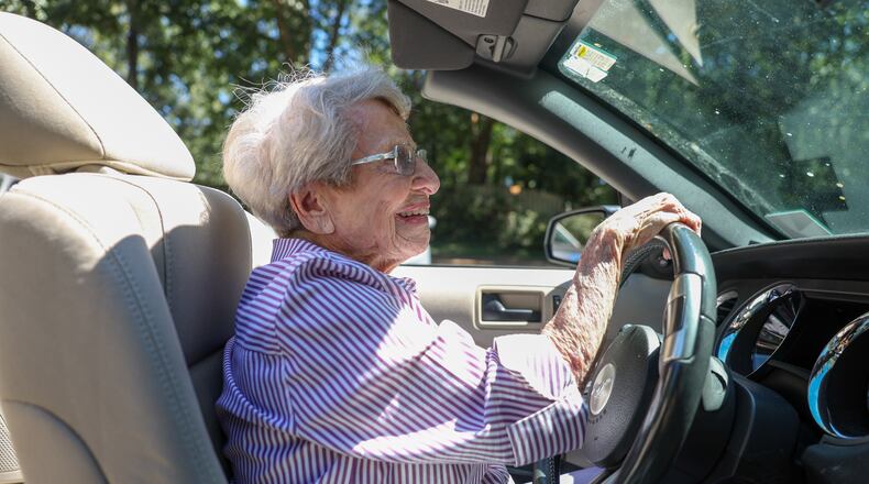 Barbara Haig, who turned 100 on Aug. 28, drives her white Ford Mustang convertible near her home in Atlanta on Wednesday, Sept. 9, 2026. (Arvin Temkar/AJC)