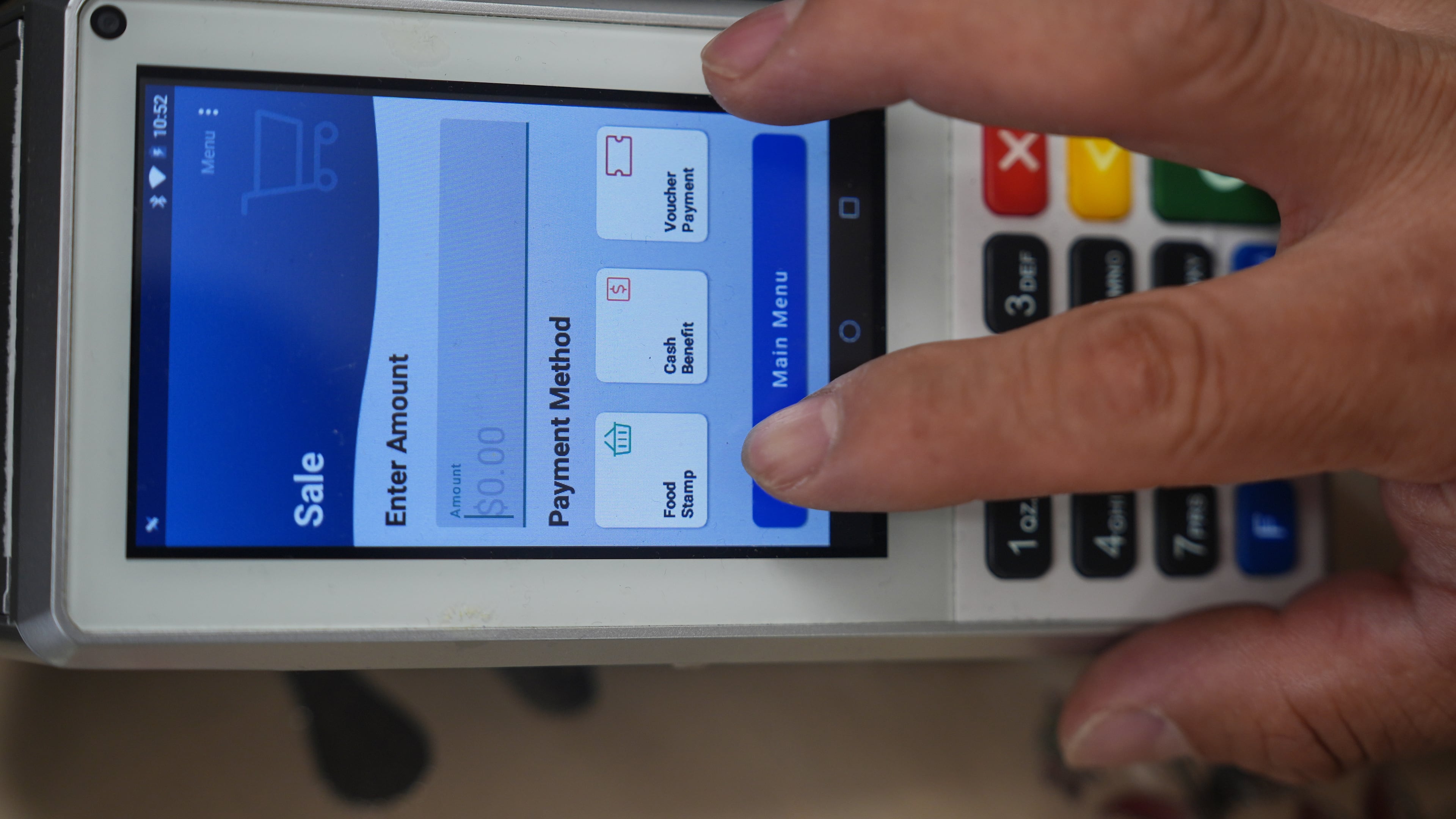 A shopper makes a purchase with food stamps on Monday, Oct. 27, 2025, in Los Angeles. (AP Photo/Damian Dovarganes)