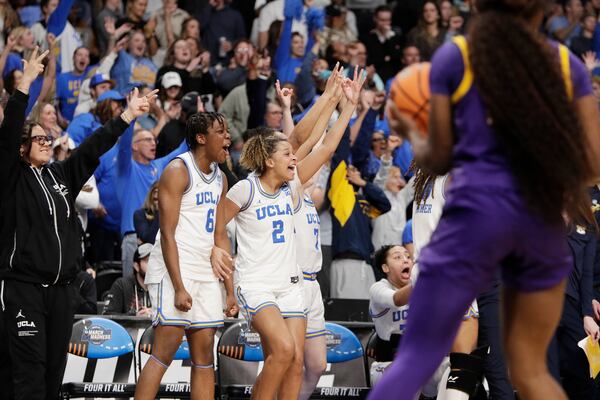 UCLA forward Zania Socka-Nguemen (6), guard Avary Cain (2) and guard Elina Aarnisalo (7) celebrated from the bench during the second half against LSU in the Elite Eight of the NCAA college basketball tournament, Sunday, March 30, 2025, in Spokane, Wash. (AP Photo/Young Kwak)