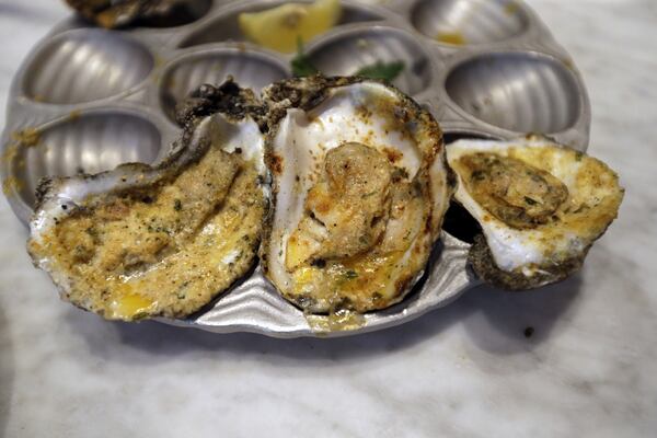 FILE - Baked oysters are displayed at the Bourbon House Restaurant in New Orleans, Tuesday, June 24, 2014. (AP Photo/Gerald Herbert, File)