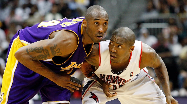 The Lakers' Kobe Bryant and the Hawks' Jamal Crawford battle for position in a 2010 game.  Curtis Compton ccompton@ajc.com