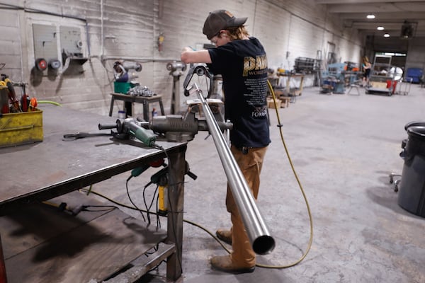 Highland Forge employee Josh Strange polishes a rod at the company’s manufacturing facility in Atlanta on Thursday, July 24, 2025. (Natrice Miller/AJC) 
