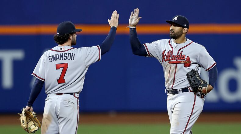 Dansby Swanson and Matt Kemp celebrate a 3-1 win over the New York Mets in the 12th inning on April 5, 2017, at Citi Field in New York City.