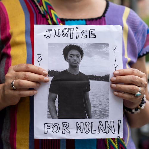 FILE - A person holds a picture of Nolan Xavier Wells during a news conference at National Action Network headquarters, Friday, July 10, 2026, in New York. (AP Photo/Yuki Iwamura, File)