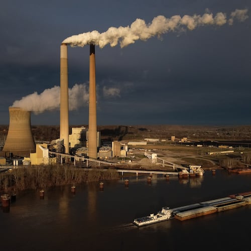 FILE - A barge on the Ohio River moves past the Mountaineer Power Plant, a coal-fired power plant near New Haven, W.Va., March 13, 2026. (AP Photo/Carolyn Kaster, File)