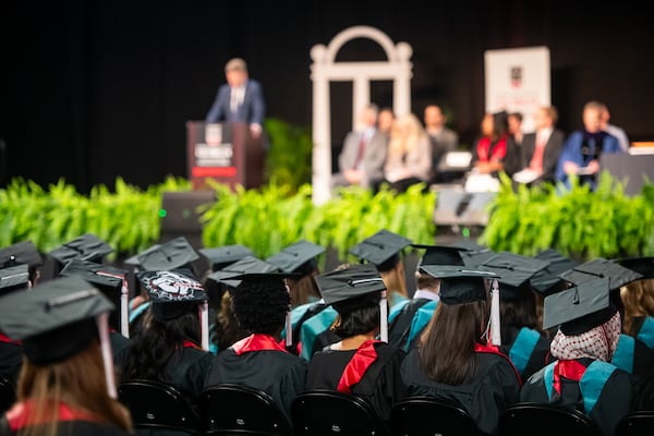 Graduates watch as AJC chief political reporter Greg Bluestein delivers the convocation address at the University of Georgia's School of Public and International Affairs on May 8, 2026. (Justin Evans for the AJC)