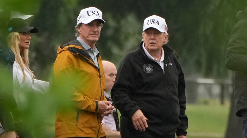 President Donald Trump, from right, and Interior Secretary Doug Burgum tour the East Potomac Park golf course, Sunday, June 28, 2026, in Washington. (AP Photo/Mark Schiefelbein)