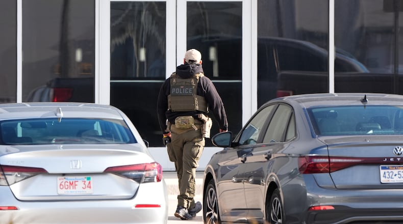 An ICE agent stands outside a warehouse as federal officials tour the facility to consider repurposing it as an ICE detention facility, Thursday, Jan. 15, 2026, in Kansas City, Mo. (AP Photo/Charlie Riedel)