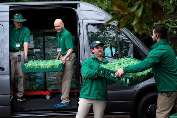 Workers deliver sandwiches at the Masters.