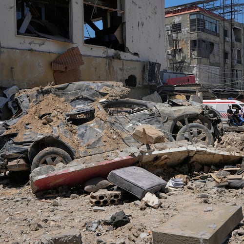 A car lies amidst debris following an Israeli airstrike in the southern port city of Tyre, Friday, June 12, 2026. (AP Photo/Mohammed Zaatari)