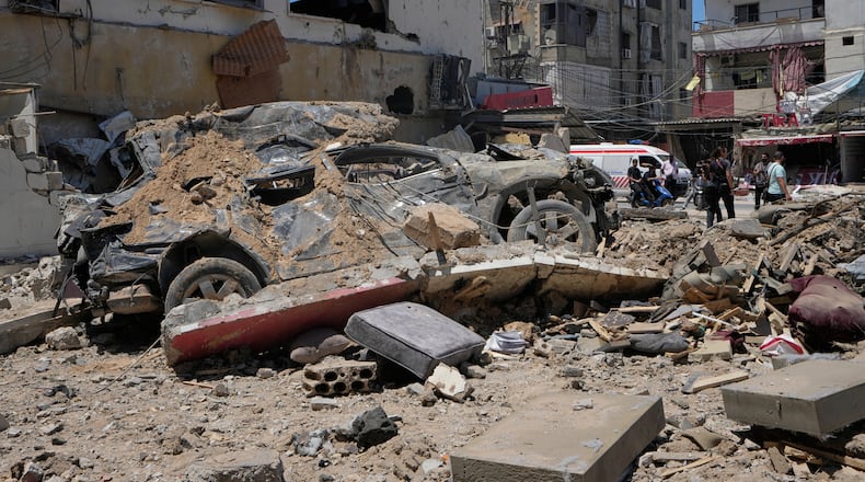 A car lies amidst debris following an Israeli airstrike in the southern port city of Tyre, Friday, June 12, 2026. (AP Photo/Mohammed Zaatari)