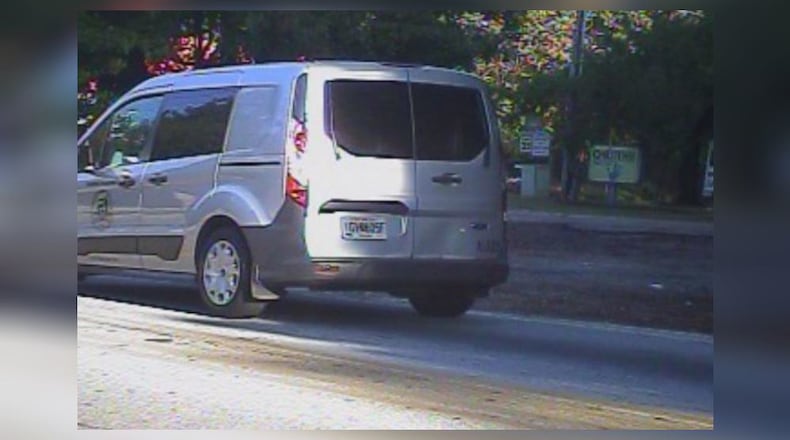 Authorities are searching for a man accused of pulling a gun on a couple, shooting the boyfriend and carjacking a DeKalb Watershed Management van.