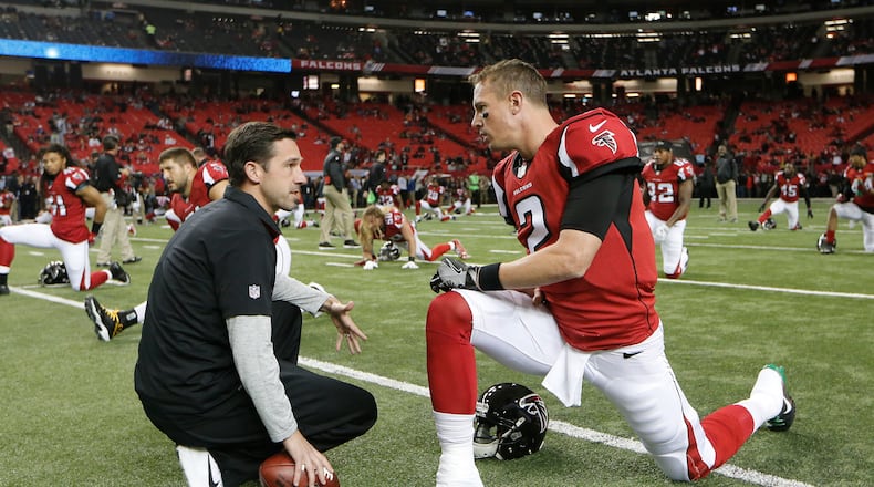 Atlanta Falcons quarterback Matt Ryan speaks with offensive coordinator Kyle Shanahan before a game between the Atlanta Falcons and the Kansas City Chiefs on Sunday, Dec. 4, 2016, in Atlanta. (AP Photo/John Bazemore)