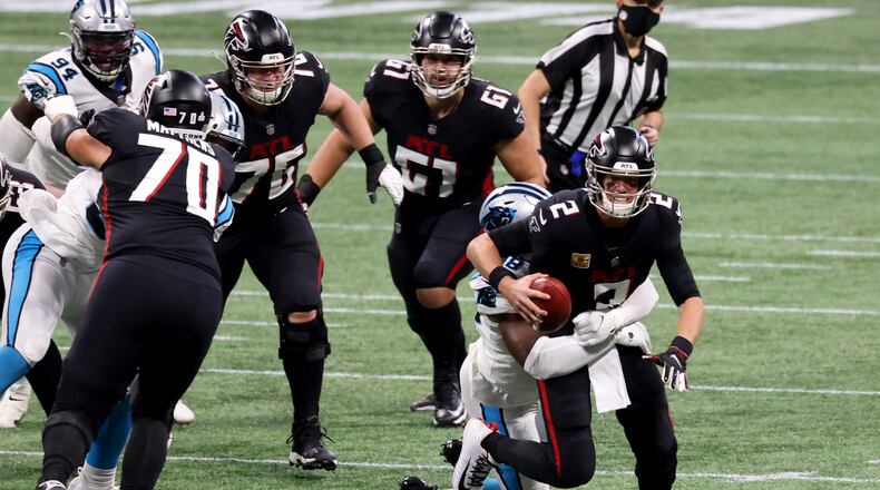 Atlanta Falcons quarterback Matt Ryan (2) is sacked by Carolina Panthers defensive end Marquis Haynes (98) in the second quarter on Sunday, Oct. 11, 2020 at Mercedes-Benz Stadium in Atlanta, Georgia. (Jason Getz/Atlanta Journal-Constitution/TNS)