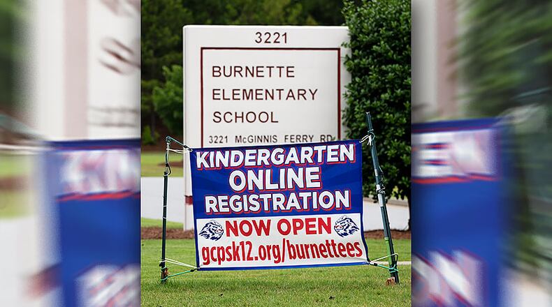 A banner advertising online kindergarten registration hangs in front of Burnette Elementary School on McGinnis Ferry Road on June 23, 2020. Gwinnett is seeing school registration numbers that are down considerably from projections.