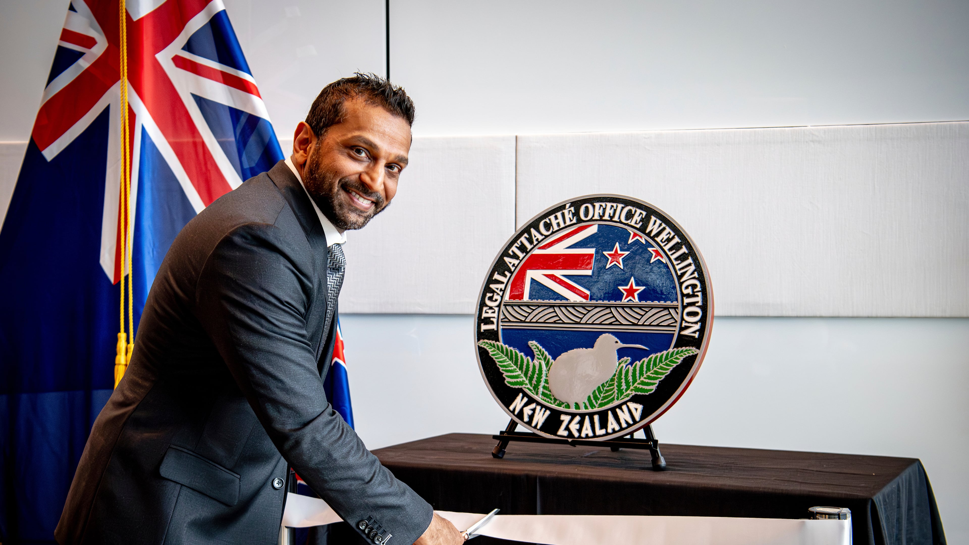 FILE - In this photo released by the US Embassy in Wellington, New Zealand, FBI Director Kash Patel cuts the ribbon at the official opening of the FBI office in Wellington, New Zealand, July 31, 2025. (Ola Thorsen/US Embassy via AP, File)