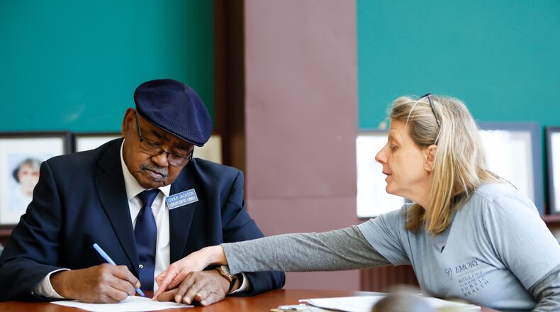 Emory researcher Melanie Pearson presents documents to Rome resident Alvin Jackson  on Sunday, February 2, 2025, for approval to participate in a study that aims to identify PFAS, commonly referred to as “forever chemicals,” through blood screening.
(Miguel Martinez/ AJC)