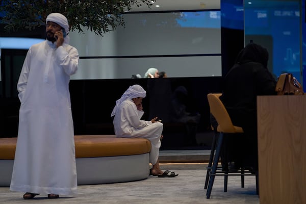 Emiratis are seen in the Dubai Financial Market in Dubai, United Arab Emirates, Monday, April 7, 2025. (AP Photos/Fatima Shbair)