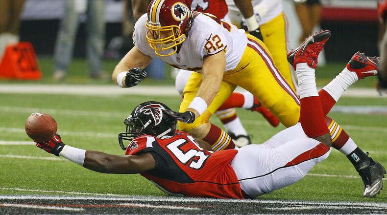 Falcons linebacker Joplo Bartu nearly intercepts a pass from Redskins quarerback Kirck Cousins to tight end Logan Paulsen as it bounces off his hand during 1st half action in a NFL football game on Sunday, Dec. 15, 2013, in Atlanta.