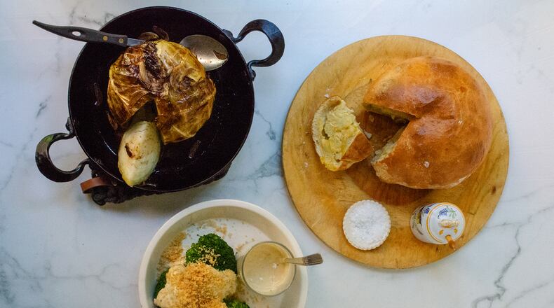 Slow Roast Cabbage (clockwise from upper left), Cauliflower en Croute and Broccoli Caesar are featured as recipes for cooking whole vegetables. (Virginia Willis for The Atlanta Journal-Constitution)
