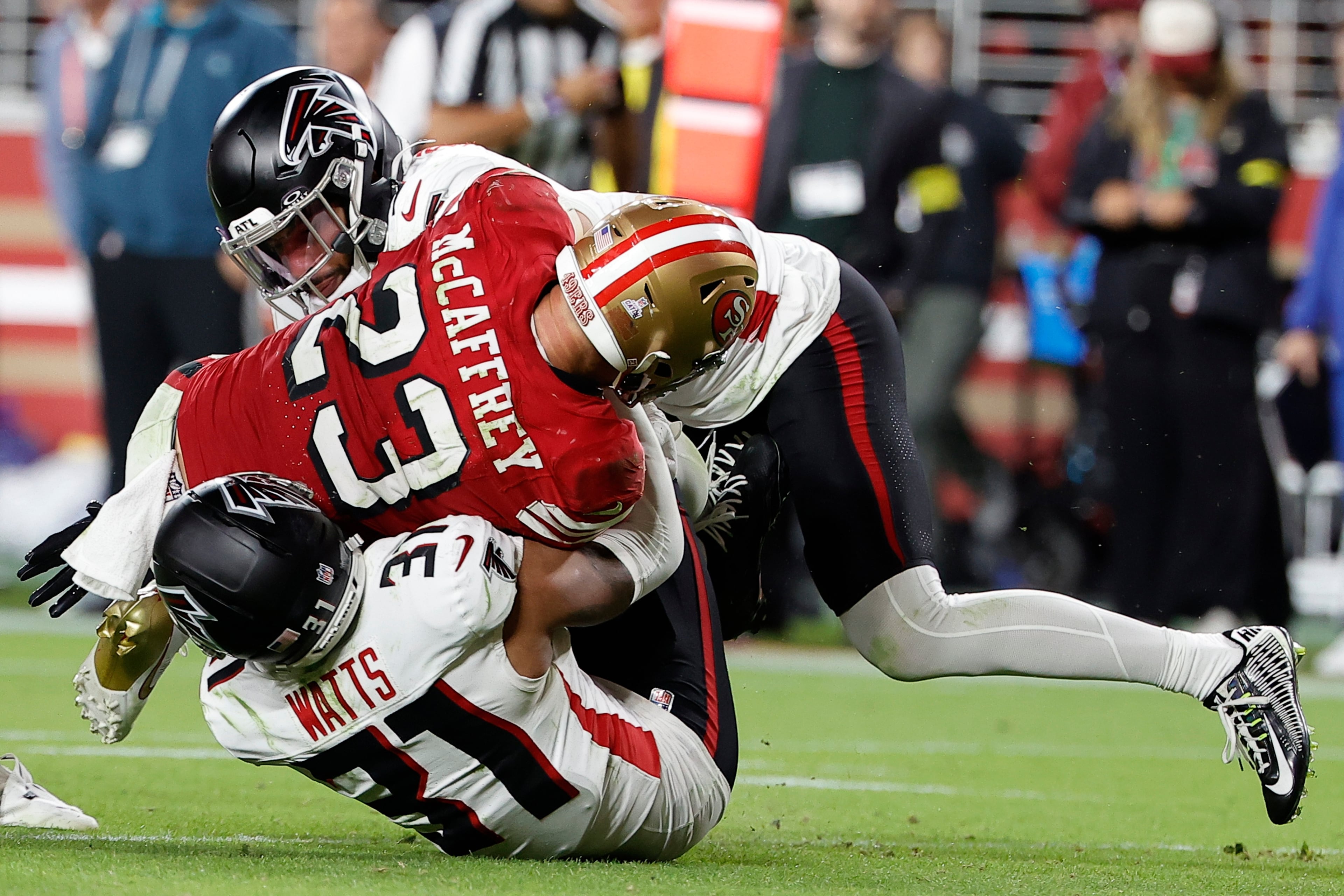 Atlanta Falcons safety Xavier Watts (bottom) tackles San Francisco 49ers running back Christian McCaffrey during the second half of an NFL football game on Sunday, Oct. 19, 2025, in Santa Clara, Calif. (Kelley L Cox/AP)