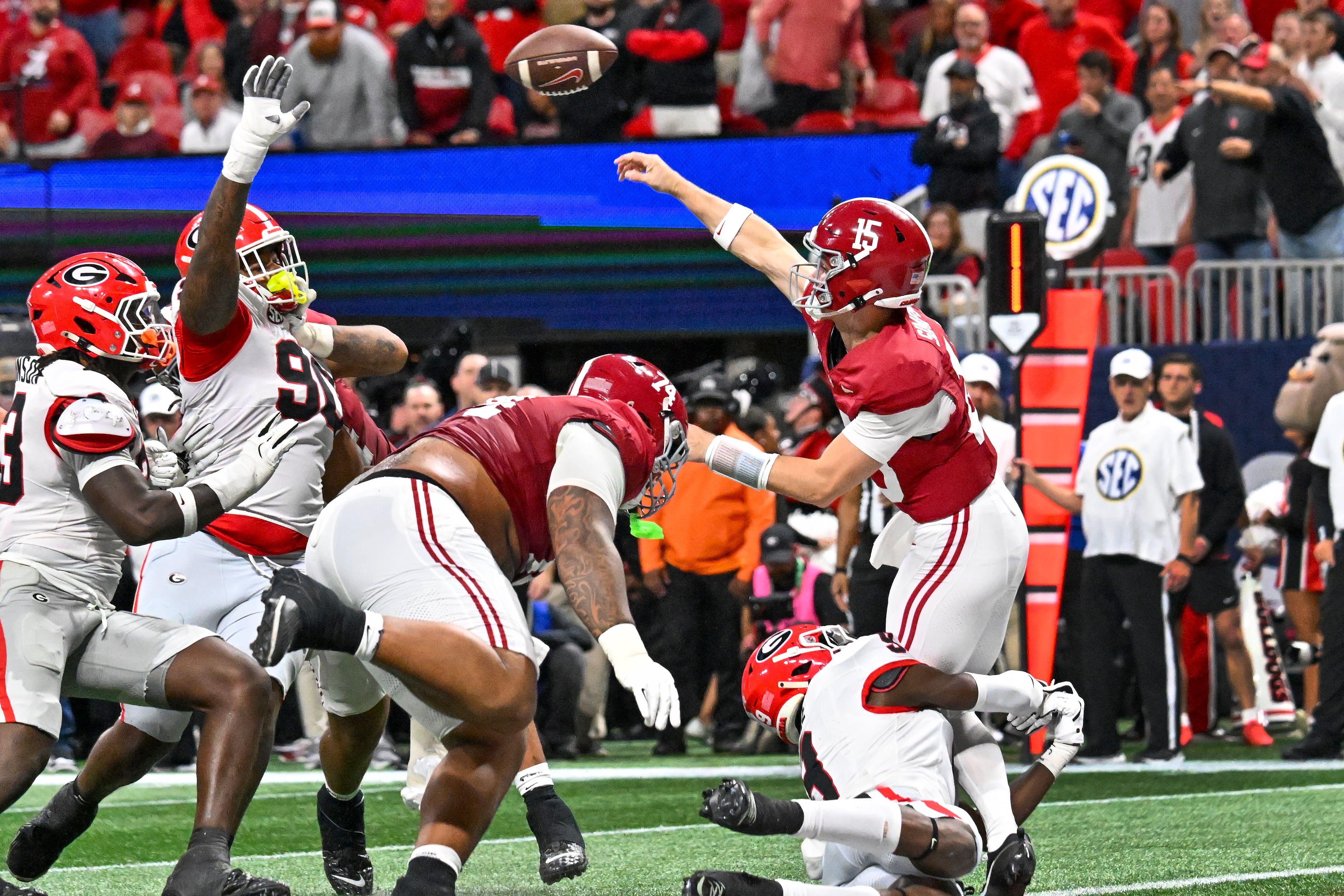 Alabama quarterback Ty Simpson (15) throws under pressure form Georgia defensive lineman Elijah Griffin (90) during the second quarter of the SEC Championship game at Mercedes-Benz Stadium, Saturday, Dec. 6, 2025, in Atlanta. (Hyosub Shin / AJC)