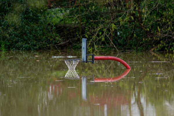 The rising waters of the Licking River touch the basketball hoop at Max Goldberg Park, Saturday, April 5, 2025, in Falmouth, Ky. (AP Photo/Carolyn Kaster)