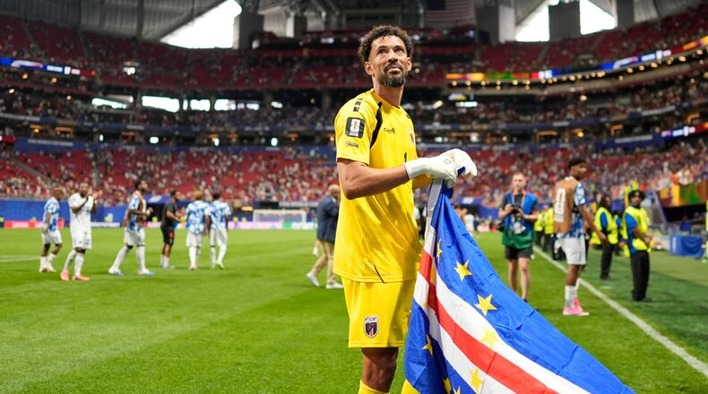 Cape Verde goalkeeper Vozinha celebrates as holds the flag of his country after the World Cup Group H soccer match between Spain and Cape Verde in Atlanta, Monday, June 15, 2026. (AP Photo/Mike Stewart)