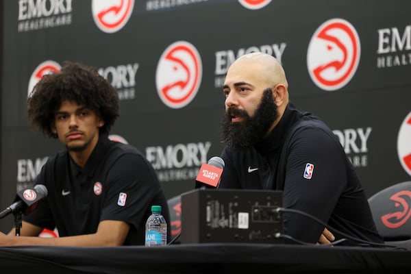 Hawks general manager Onsi Saleh (right) and first-round pick Asa Newell during a Friday news conference.