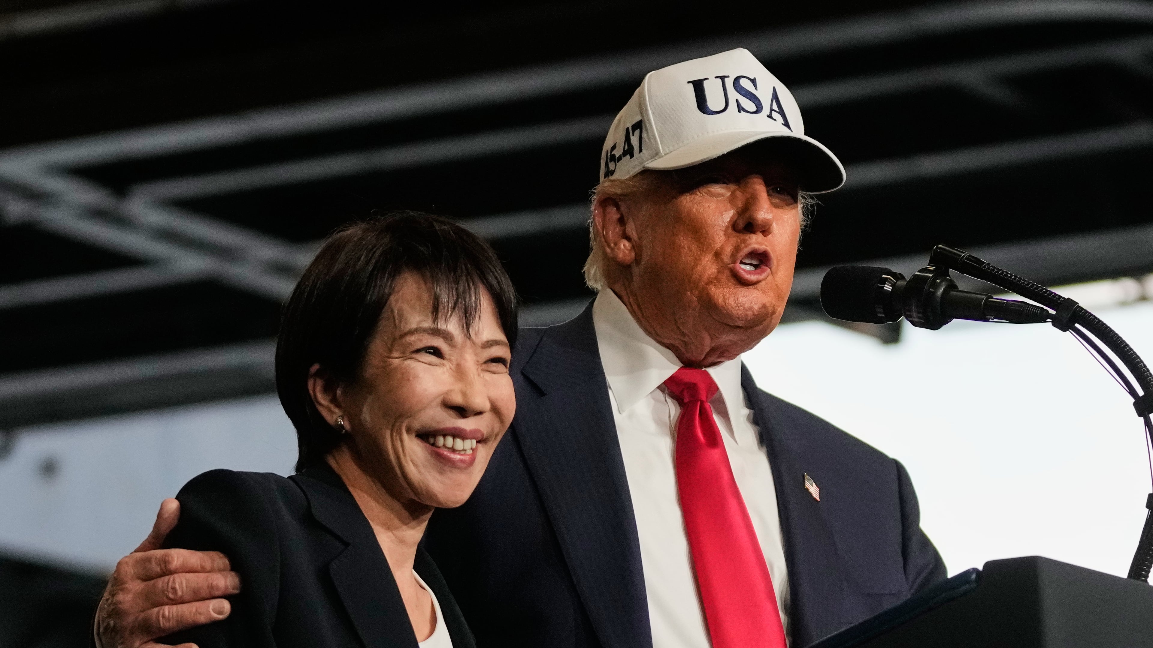President Donald Trump, with Japanese Prime Minister Sanae Takaichi, speaks to members of the military aboard the USS George Washington, an aircraft carrier docked at an American naval base, in Yokosuka, Tuesday, Oct. 28, 2025. (AP Photo/Mark Schiefelbein)