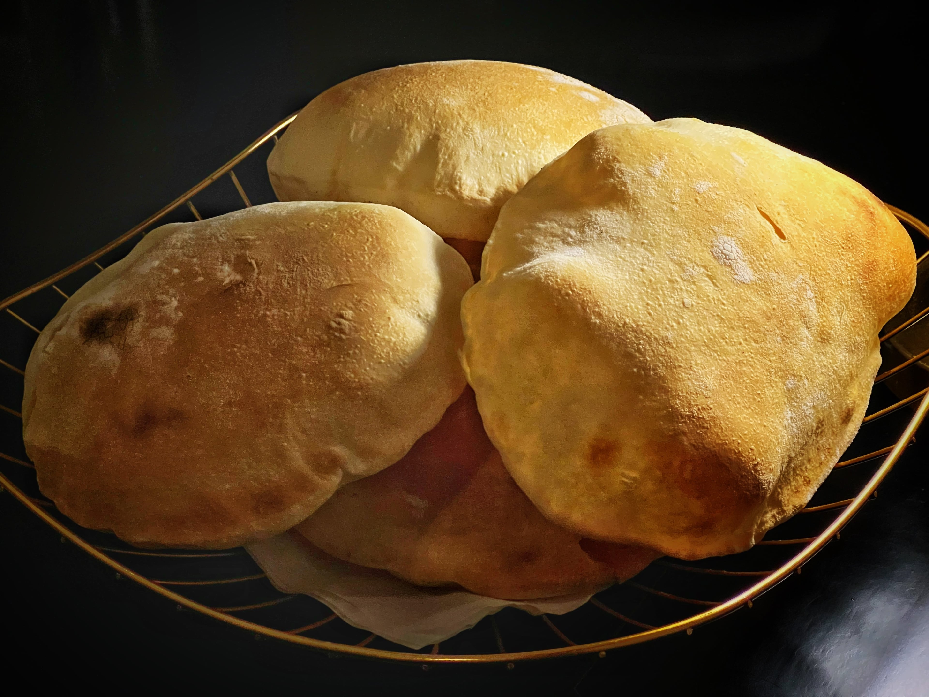 Zakia's pitas, which are cooked in a special oven in about 70 seconds, often arrive at the table still puffed and warm. (Henri Hollis/AJC)